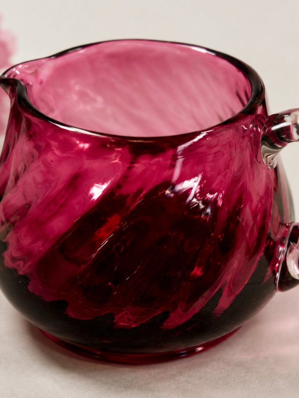 CS-12--Cranberry Ruby Red Art Glass Creamer – Draped Optic Pattern – Clear Handl